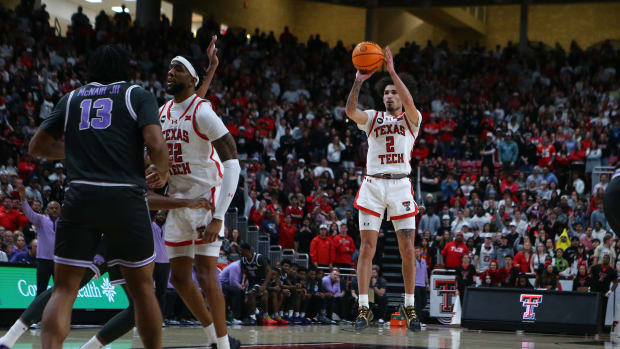 Jan 13, 2024; Lubbock, Texas, USA; Texas Tech Red Raiders guard Pop Isaacs (2) takes a jump shot against Kansas State Wildcats center Will McNair Jr. (13) in the second half at United Supermarkets Arena. Mandatory Credit: Michael C. Johnson-USA TODAY Sports